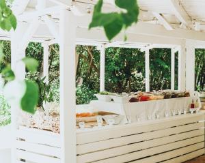 a buffet of food on display at a wedding reception at Ile Des Deux Cocos in Blue Bay +28 photos