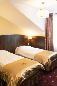 um quarto de hotel com duas camas e uma janela em Hotel Kalchem em Brzozie