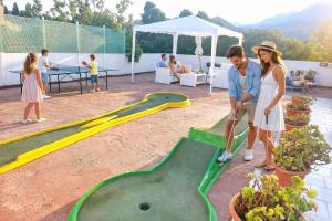 a man and a woman playing a game of golf at Seafront Studios and Apartments in Chios