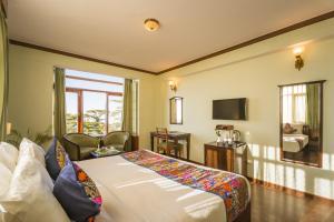 a hotel room with a bed and a television at Tripli Hotels Le Royale, Shimla in Shimla
