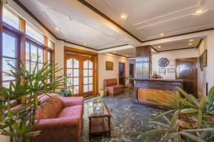 a living room with a couch and a piano at Tripli Hotels Le Royale, Shimla in Shimla +60 photos