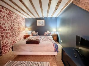 a bedroom with a bed and a flat screen tv at Le Napoléon in Compiègne