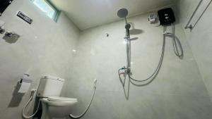 a bathroom with a shower and a toilet at Sigiriya Hidden Home Stay in Sigiriya