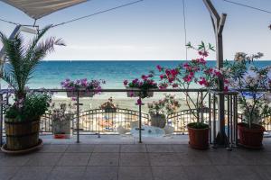 a view of the beach from a patio with flowers at Mirage Collective in Nesebar
