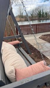 a pillow hanging from a porch swing at Baba néni nyaralója in Szarvas