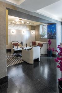 a hotel lobby with couches and tables and flowers at Dareyn Boutique in Istanbul