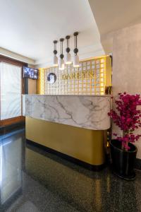 a lobby of a restaurant with a marble counter and flowers at Dareyn Boutique in Istanbul