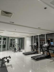a gym with a row of treadmills and exercise bikes at Yugen Studio in Davao City