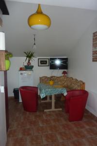 a living room with a table and a couch at Gite D'étape de roslaye in Gourin