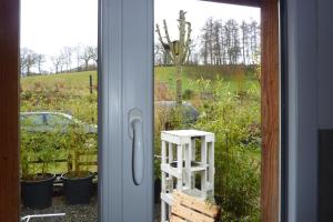 a view of a garden from a window with a ladder at Gite D'étape de roslaye in Gourin +3 photos