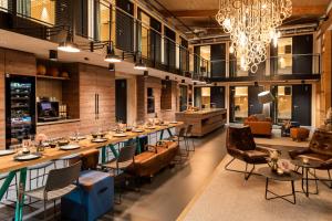 a large dining room with a long table and chairs at vevio - Hotel & Events in Spiesen-Elversberg