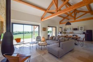 a living room with a couch and a table at Domaine d'Essendiéras in Saint-Médard-dʼExcideuil
