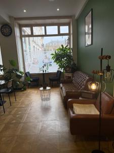 a living room with a couch and a large window at Hôtel de la paix in Limoges +69 photos