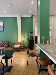a lobby with a bar with chairs and a couch at Hôtel de la paix in Limoges