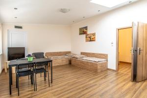 a living room with a table and a couch at K-plus penzión in Štúrovo