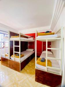 a room with three bunk beds in it at VPlus Hotel in Siem Reap