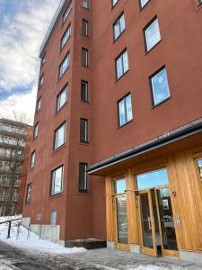 a tall brick building with doors in front of it at Nordic NOVA Studio in Stockholm