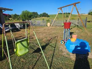 a swing set in a yard with two swings at Millésime in Perville