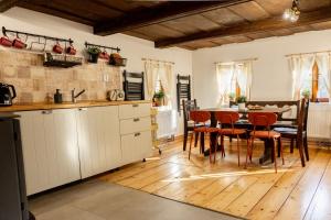 a kitchen and dining room with a table and chairs at V Údolí in Jablonné v Podještědí