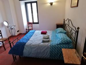 a bedroom with a bed with a blue comforter at Antico Mulino in Imperia