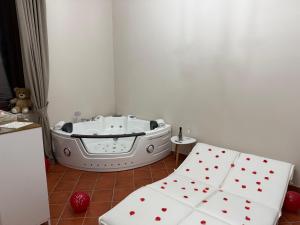 a bath tub in a room with red hearts at La Dimora in Morino +26 photos
