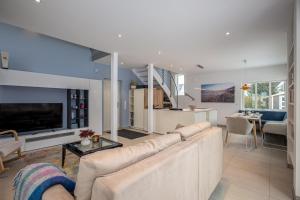 a living room with a large couch and a table at Chalet Wacholder in Dierhagen