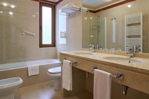 a bathroom with a sink and a toilet and a tub at II Castillas Madrid in Madrid +24 photos