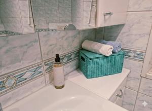 a bathroom with a bottle of wine sitting on the sink at Ferienwohnung Saller in Weißenbrunn +24 photos