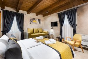 a bedroom with a bed and a living room at Luxury Jerini Barn in Krk +52 photos