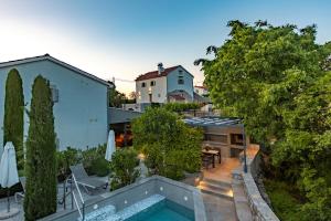 an aerial view of a house with a swimming pool at Luxury Jerini Barn in Krk