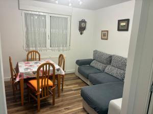 a living room with a table and a couch at Puentecuervo 3 in Pancorbo