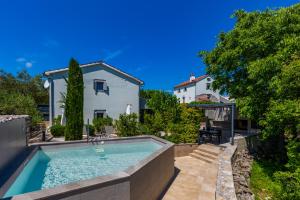 a swimming pool in the backyard of a house at Luxury Jerini Barn in Krk