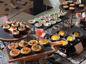 a display of cupcakes and muffins on trays at Away Bangkok Sukhumvit in Bangkok