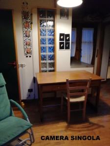 a table and chairs in a room with wine bottles at casaNARDIELLO in Capua