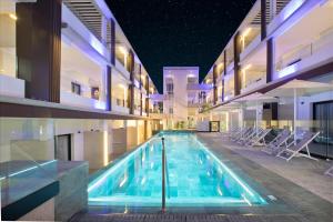 a swimming pool in a building at night at Hotel Coral Cotillo Reef in El Cotillo