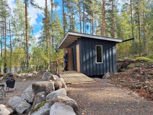 a man standing on a wooden ramp in a small cabin at Beautiful Cottage at Lake Saimaa, Rantamaja in Juva