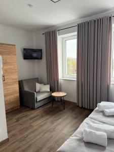 a hotel room with a bed and a couch at Hostel Granat in Czekanów