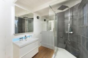 a bathroom with a shower and a sink and a mirror at Walters on The Digey - 100m to beach - pets allowed in St Ives +21 photos
