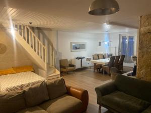 a living room with a couch and a dining room at Le Loft Dolois, Maison Loft in Dole