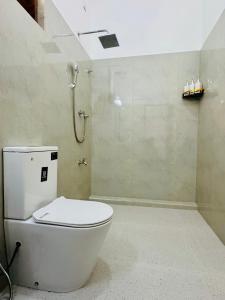 a bathroom with a toilet and a shower at Ayubowan Yala in Tissamaharama