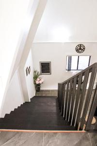 a staircase in a house with a stair case at GREEN TREES CHALET Australia Zoo close by in Landsborough