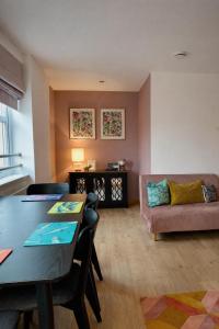 a living room with a table and a couch at The Inver Nest in Inverness