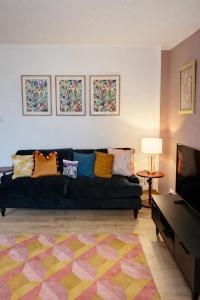 a living room with a couch and a television at The Inver Nest in Inverness