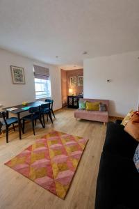 a living room with a table and a dining room at The Inver Nest in Inverness