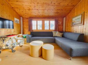 a living room with a couch and a table at Chalet Marguerite in Flums
