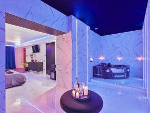 a room with a bed and a table with candles at Jacuzzi LoveAparts Marki Romantic Getaway in Marki