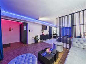 a living room with a couch and a table at Jacuzzi LoveAparts Marki Romantic Getaway in Marki