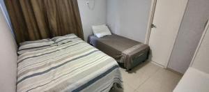 a small room with a bed and a chair at Porto Real Resort - Leisure and Fun in Mangaratiba +16 photos