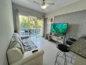 a living room with a couch and a flat screen tv at Porto Real Resort - Leisure and Fun in Mangaratiba