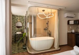 a bath tub in a bathroom with a shower at Saigon Maison 1988 BUI VIEN Centre in Ho Chi Minh City +39 photos